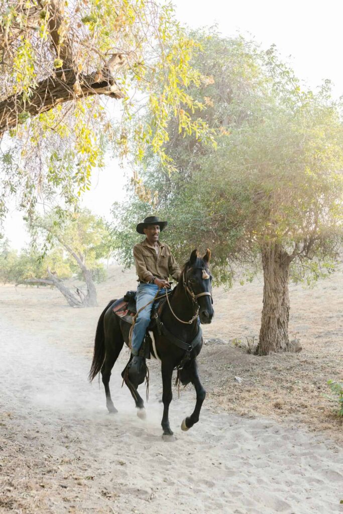 Man riding black horse on ranch